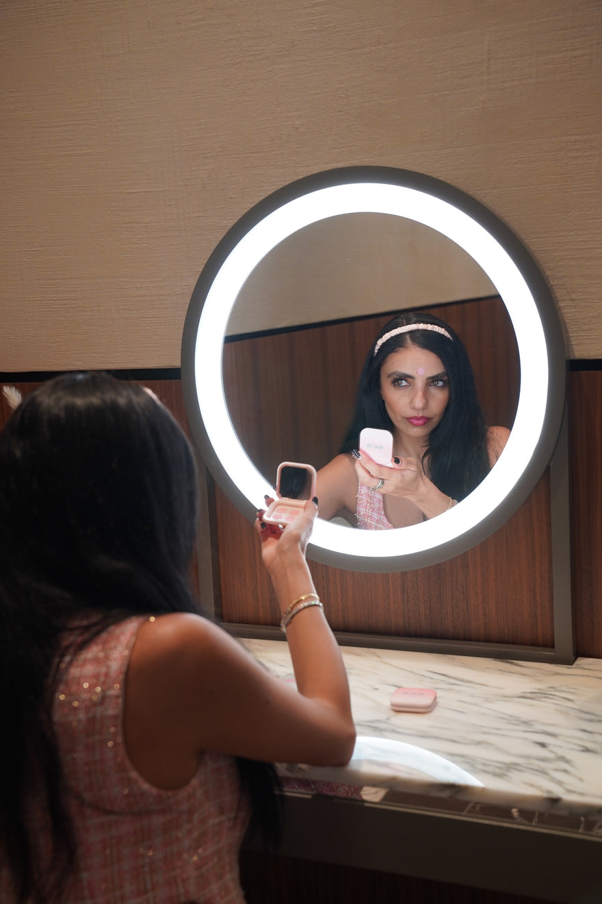 girl looking in mirror with pimple patch case